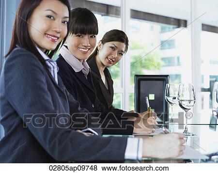 three business woman looking at camera View Large Photo Image Stock Photo - three business woman looking at camera. Fotosearch