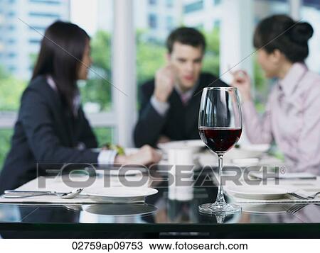 Three people talking at end of table View Large Photo Image Stock Image - Three people talking at end of table. Fotosearch