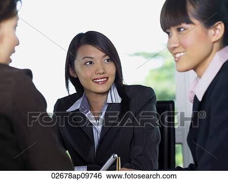 three woman smiling at each other View Large Photo Image Stock Photograph - three woman smiling at each other. Fotosearch