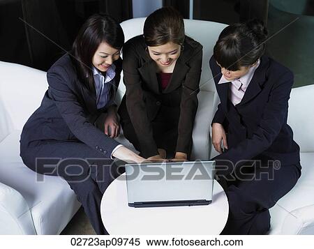 three woman working at laptop together View Large Photo Image Stock Photography - three woman working at laptop together. Fotosearch
