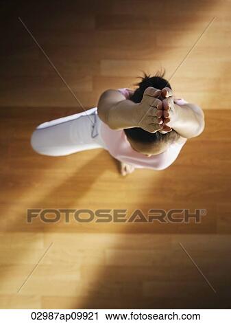 Stock Image - top view of girl doing yoga. Fotosearch
