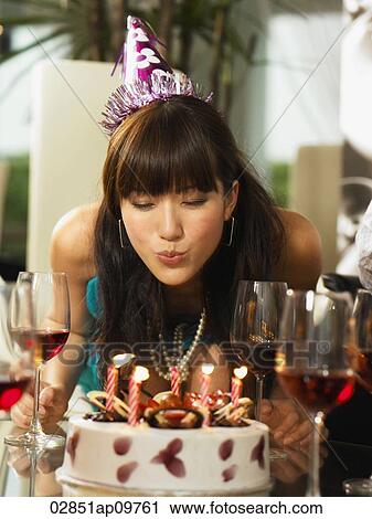 woman blowing out candles on birthday cake View Large Photo Image Stock Image - woman blowing out candles on birthday cake. Fotosearch