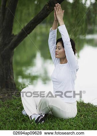 woman doing yoga outdoors View Large Photo Image Stock Photo - woman doing yoga outdoors. Fotosearch