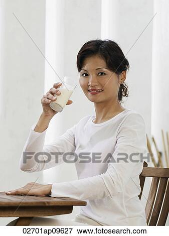 woman drinking glass of milk View Large Photo Image Stock Photo - woman drinking glass of milk. Fotosearch