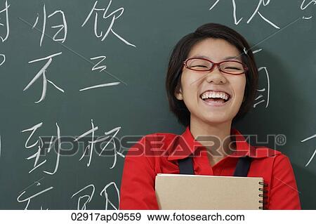 woman laughing in front of Chinese characters written on chalk board View Large Photo Image Stock Photo - woman laughing in front of Chinese characters written on chalk board. Fotosearch