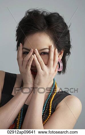 woman playing peekaboo with camera View Large Photo Image Stock Image - woman playing peekaboo with camera. Fotosearch