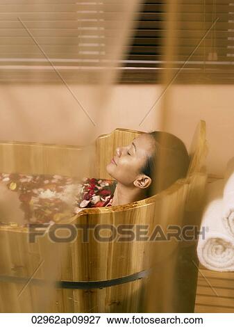 woman relaxing in wooden spa tub View Large Photo Image Stock Photo - woman relaxing in wooden spa tub. Fotosearch
