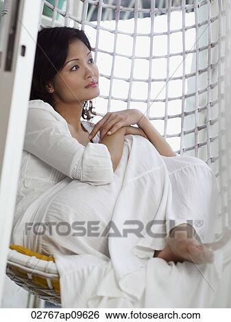 woman sitting in chair hammock View Large Photo Image Stock Photograph - woman sitting in chair hammock. Fotosearch