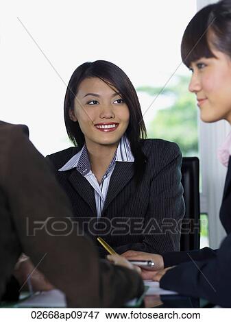 woman smiling at other woman View Large Photo Image Stock Photo - woman smiling at other woman. Fotosearch