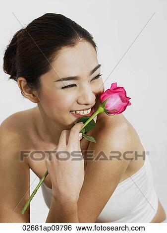 woman smiling with rose View Large Photo Image Stock Photograph - woman smiling with rose. Fotosearch