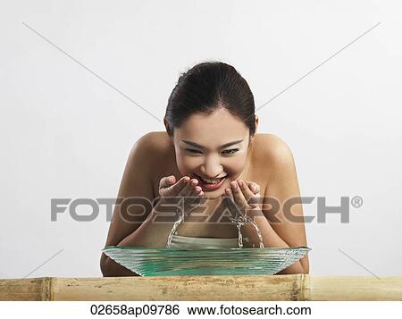 woman washing her face View Large Photo Image Stock Photograph - woman washing her face. Fotosearch