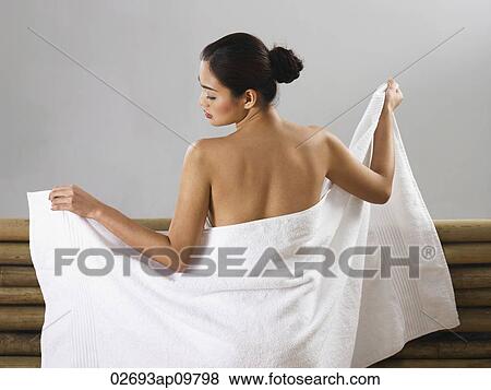 woman wrapping herself in a towel View Large Photo Image Stock Photo - woman wrapping herself in a towel. Fotosearch