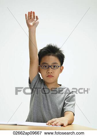 young boy raising his hand View Large Photo Image Stock Photo - young boy raising his hand. Fotosearch