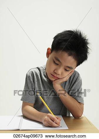 young boy working and writing View Large Photo Image Stock Image - young boy working and writing. Fotosearch