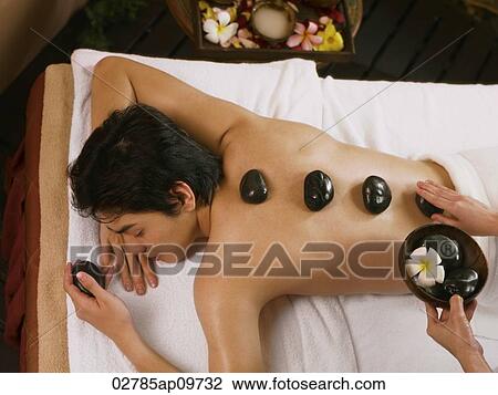 young man getting a hot stones massage View Large Photo Image Stock Image - young man getting a hot stones massage. Fotosearch