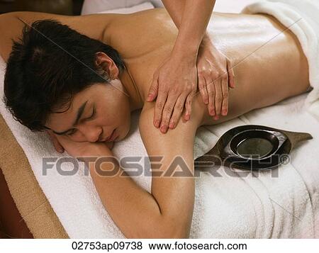 young man having a back massage View Large Photo Image Stock Photo - young man having a back massage. Fotosearch