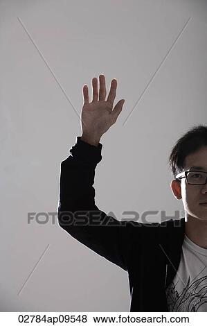 young man raising his hand View Large Photo Image Stock Photo - young man raising his hand. Fotosearch