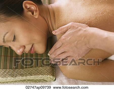 Stock Photo - young woman having a spa scrub. Fotosearch
