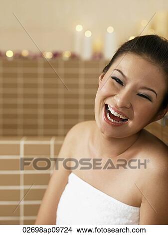 young woman in bathrobe laughing happily View Large Photo Image Picture - young woman in bathrobe laughing happily. Fotosearch