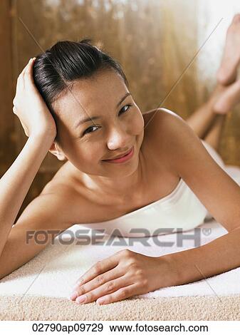 young woman in bathrobe lying down smiling View Large Photo Image Stock Photo - young woman in bathrobe lying down smiling. Fotosearch
