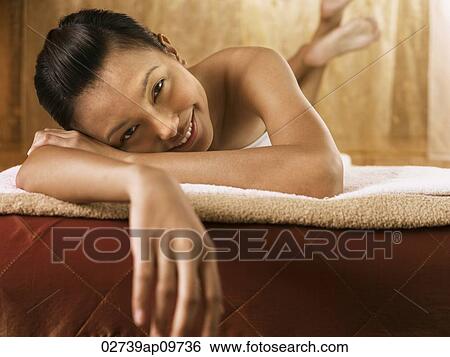"young woman in bathrobe lying down, smiling" View Large Photo Image Stock Photograph - "young woman in bathrobe lying down, smiling". Fotosearch
