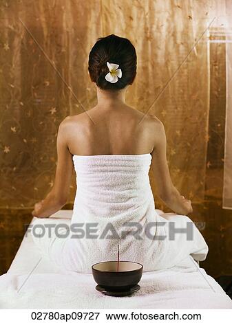 "young woman in bathrobe meditating, back facing camera" View Large Photo Image Stock Photo - "young woman in bathrobe meditating, back facing camera". Fotosearch