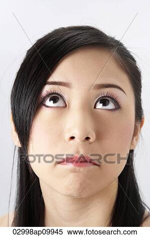 Stock Photography - young woman looking up. Fotosearch