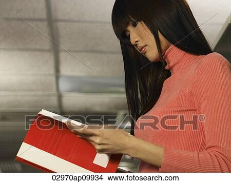 young woman reading a book View Large Photo Image Picture - young woman reading a book. Fotosearch
