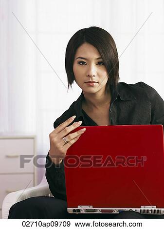 "young woman with laptop, with strong gaze" View Large Photo Image Stock Photo - "young woman with laptop, with strong gaze". Fotosearch