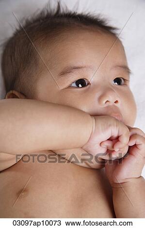 Chinese baby sucking his hand View Large Photo Image Stock Image - Chinese baby sucking his hand. Fotosearch