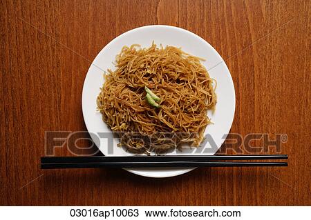 Stock Image - Chinese noodles on plate with chopsticks.. Fotosearch
