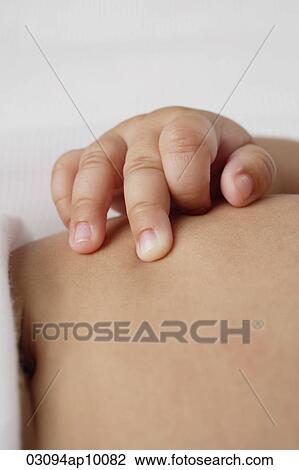 Close up of babies hand on tummy. View Large Photo Image Stock Image - Close up of babies hand on tummy.. Fotosearch