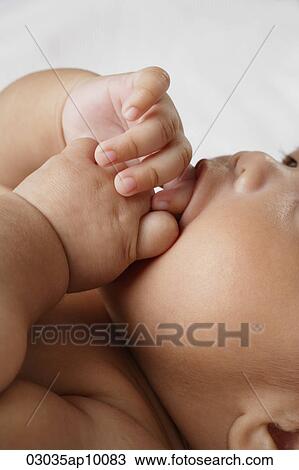 Close up of baby sucking fingers. View Large Photo Image Stock Image - Close up of baby sucking fingers.. Fotosearch