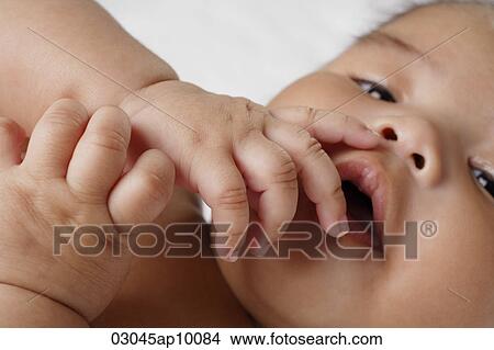 Close up of hands on babies mouth. View Large Photo Image Picture - Close up of hands on babies mouth.. Fotosearch