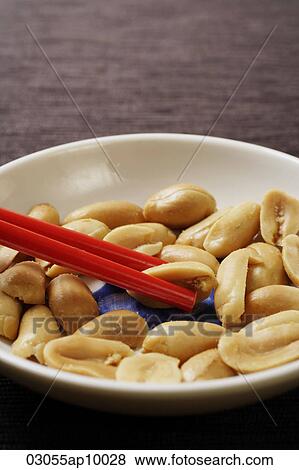 close up of red chopsticks picking up peanuts View Large Photo Image Stock Photo - close up of red chopsticks picking up peanuts. Fotosearch