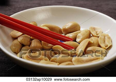 close up of red chopsticks picking up peanuts View Large Photo Image Stock Photo - close up of red chopsticks picking up peanuts. Fotosearch