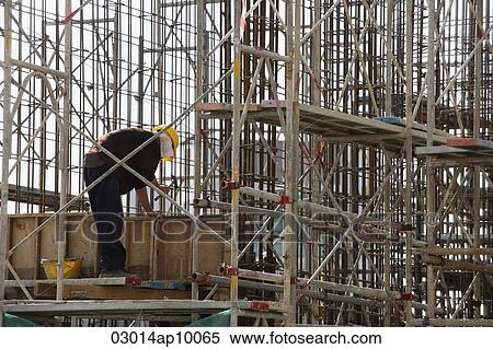 Construction worker in building frame. View Large Photo Image Stock Photography - Construction worker in building frame.. Fotosearch
