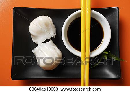 Stock Photo - dim sum on plate with soy sauce. Fotosearch