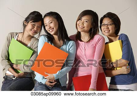 Four women holding folders. View Large Photo Image Stock Image - Four women holding folders.. Fotosearch