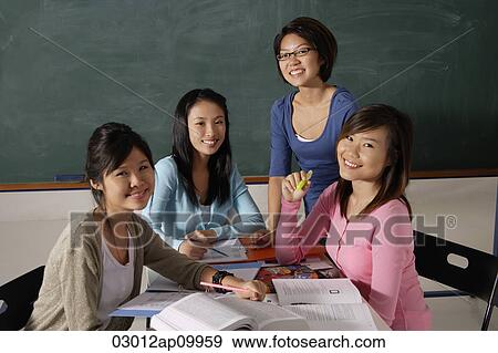 Stock Photo - Four women studying together.. Fotosearch