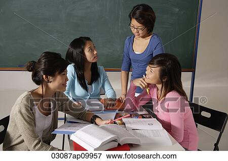 Stock Photo - Four women studying together.. Fotosearch