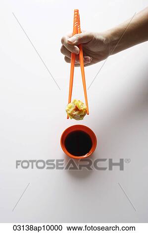 hand holding dimsum between chopsticks View Large Photo Image Stock Image - hand holding dimsum between chopsticks. Fotosearch