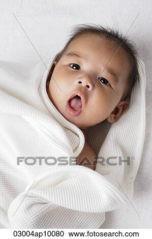 Stock Image - Head shot of Chinese baby looking at camera.. Fotosearch