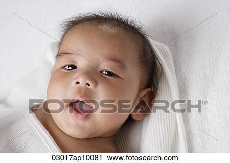 Head shot of Chinese baby smiling at camera. View Large Photo Image Stock Image - Head shot of Chinese baby smiling at camera.. Fotosearch