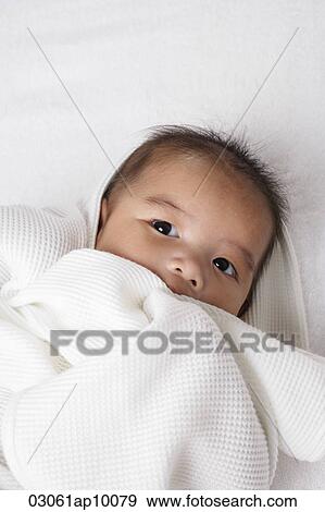 Head shot of Chinese baby wrapped up in a white blanket. View Large Photo Image Stock Photo - Head shot of Chinese baby wrapped up in a white blanket.. Fotosearch