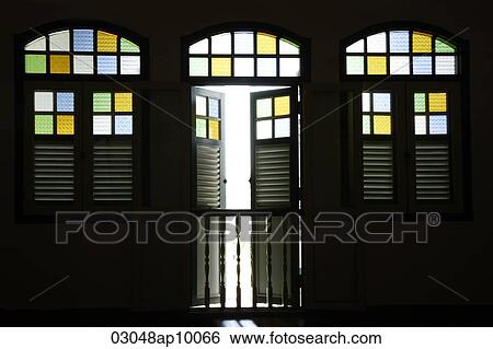 Stock Photograph - Light coming through old shop house stained glass windows.. Fotosearch