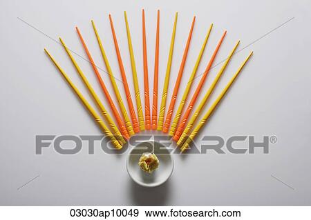 Orange and yellow chopsticks lined up over dim sum. View Large Photo Image Stock Photo - Orange and yellow chopsticks lined up over dim sum.. Fotosearch