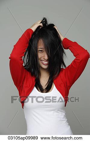 Portrait of young woman playing with her hair. View Large Photo Image Stock Photo - Portrait of young woman playing with her hair.. Fotosearch