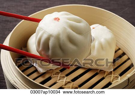 red chopstick holding dim sum (bao) View Large Photo Image Picture - red chopstick holding dim sum (bao). Fotosearch