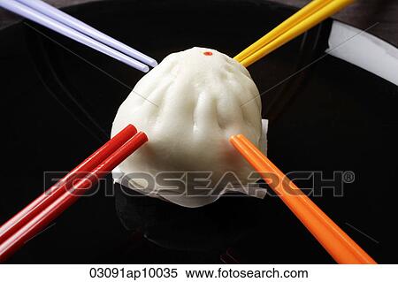 steamed bun surrounding by chopsticks View Large Photo Image Stock Photography - steamed bun surrounding by chopsticks. Fotosearch